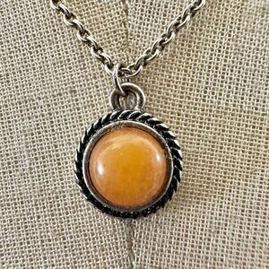 Silver tone and orange circle pendant necklace